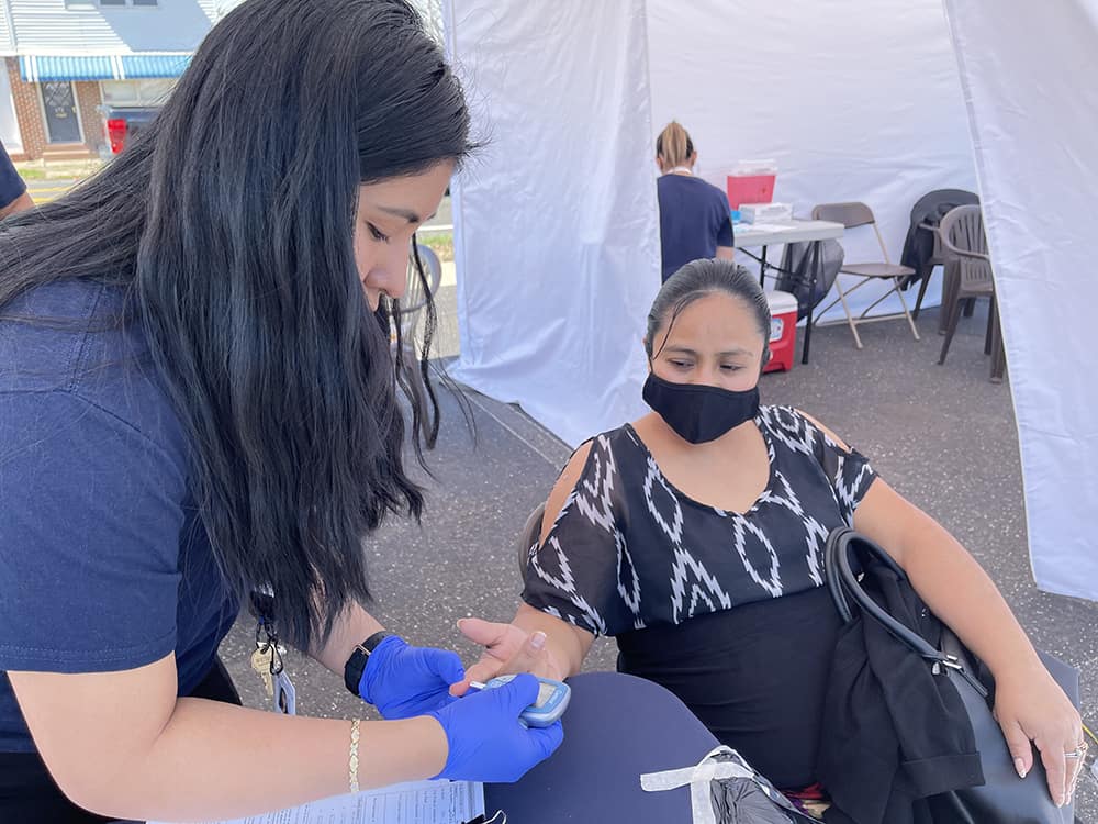 Boost NJ2 - Migrant Health Manager Anali Reyes performs a health assessment on an expectant mother.